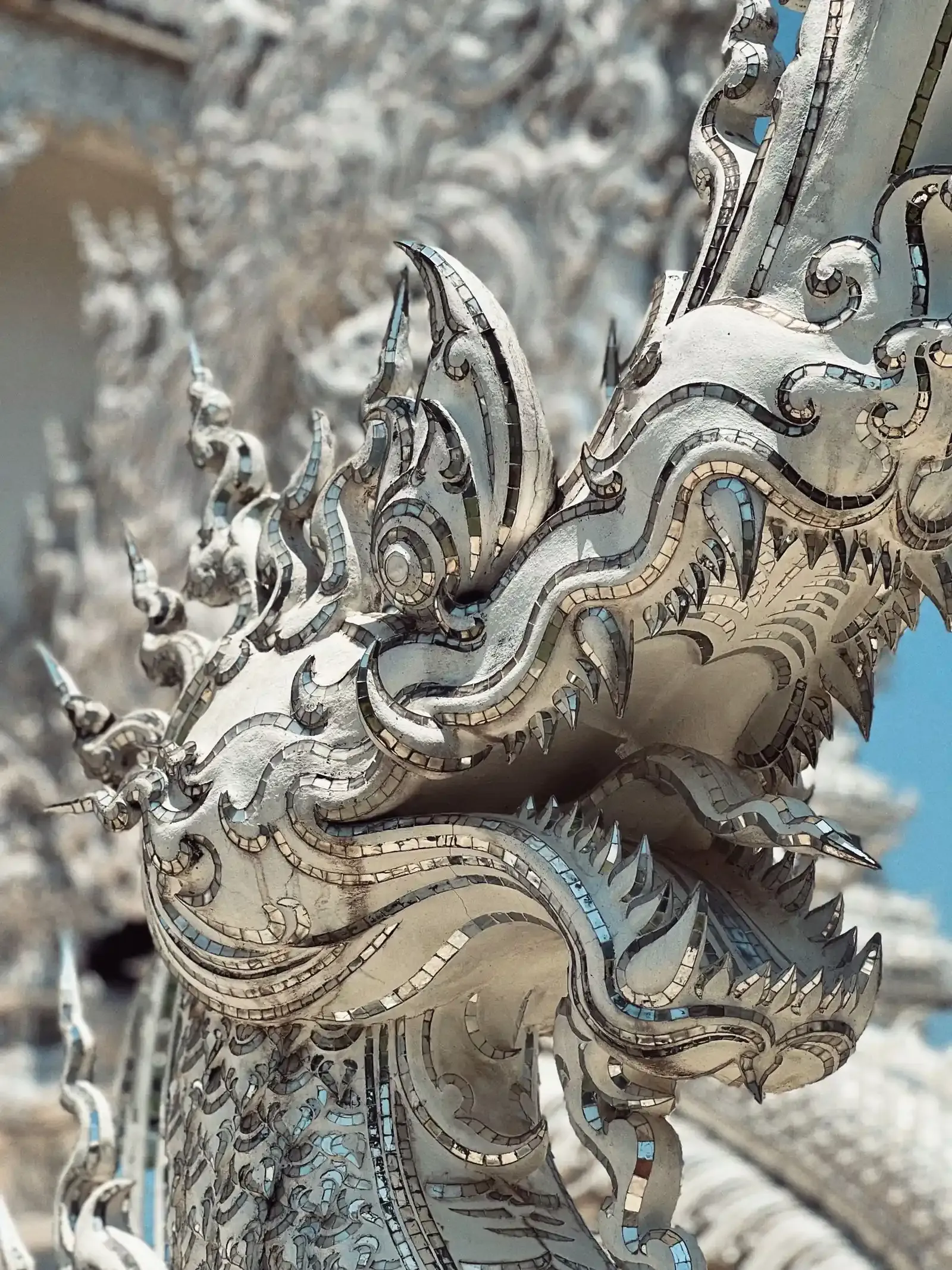 Close-up of a white naga head inlaid with mirror glass