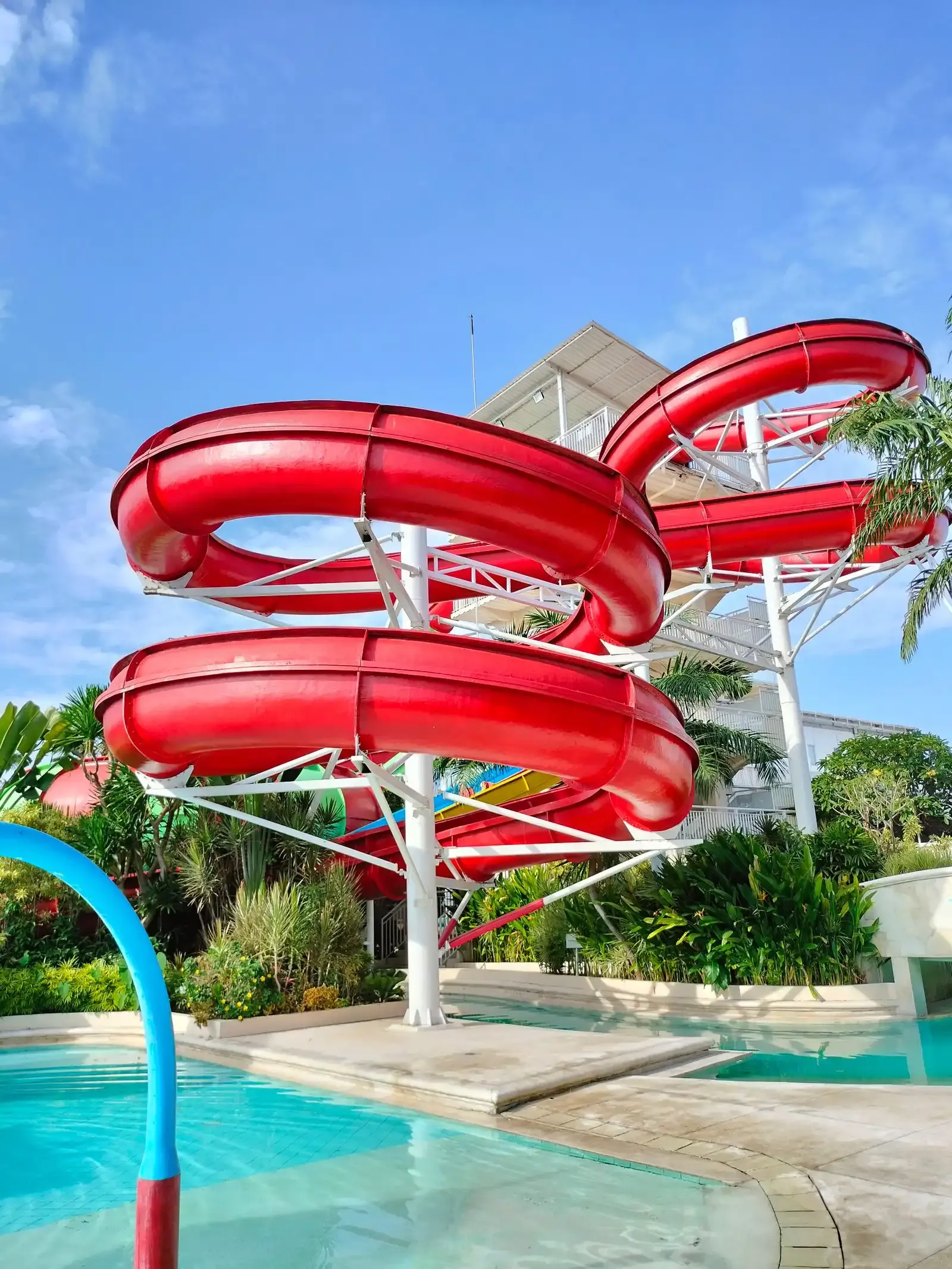 Red spiral water slides above a pool