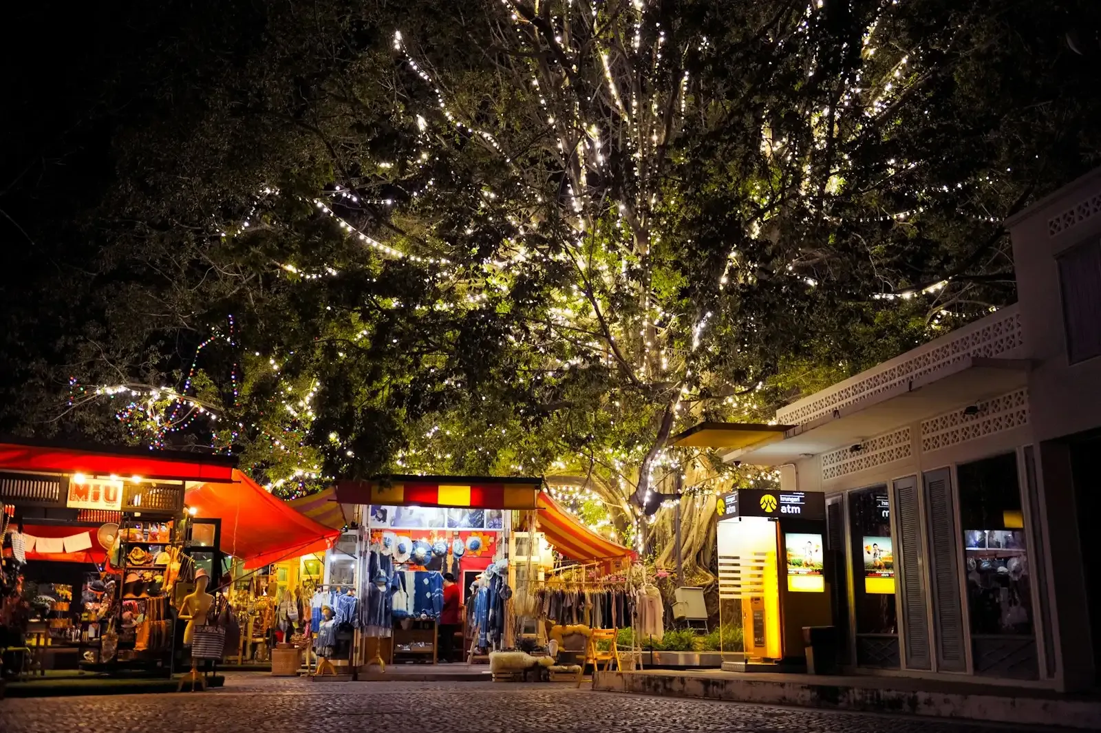 Fairy lights over shop stalls at night in Nimman, Chiang Mai